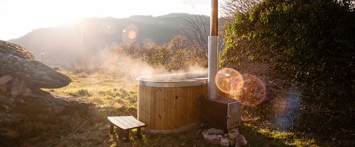 Wood fired hot tub outdoors with scenic setting